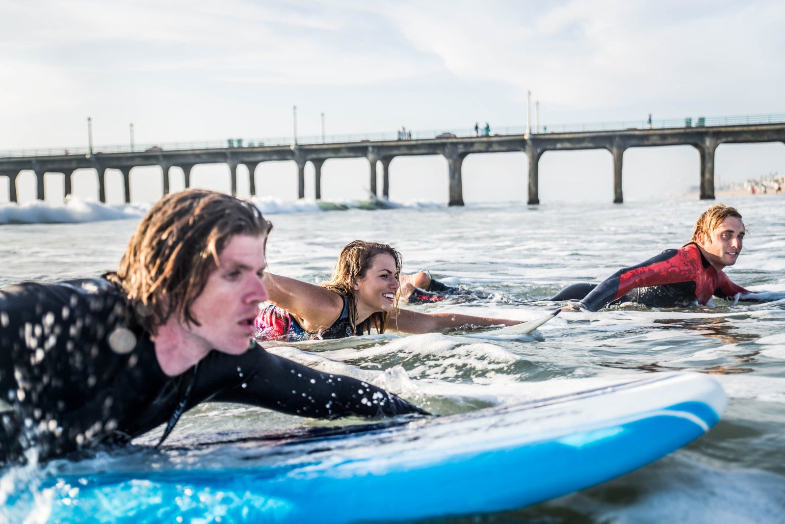 Group of friends going to surf at the beach